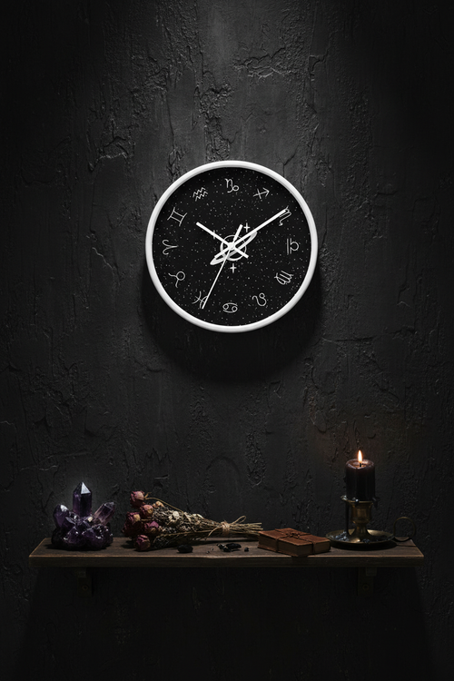 Astrology Themed Wall Clock on a dark moody wall with crystals and botanicals
